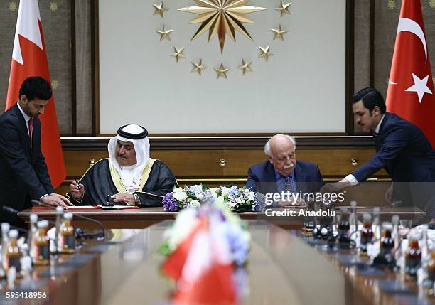 Turkish Culture and Tourism Minister Nabi Avci and Bahraini Shaikh Khalid bin Ahmed Al-Khalifa sign an agreement during an Inter-Committee Meeting at...