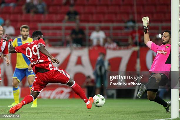 Olympiaco's Greek forward Brown Ideye in action with Arouca's Brazilian goalkeeper Rafael Bracalli during UEFA Europa League match between FC...