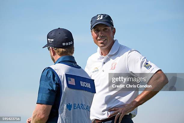 Matt Kuchar and caddie John Wood wait on the 11th green during the first round of The Barclays at Bethpage State Park on August 25, 2016 in...
