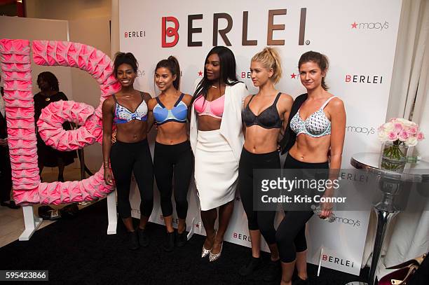 Tennis star Serena Williams poses with models during the launch of