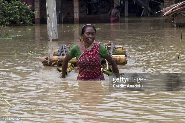 Woman wades through the floodwaters on a flooded street in the Udaynarayanpur Area in Howrah district of the West Bengal, India on August 26, 2016.