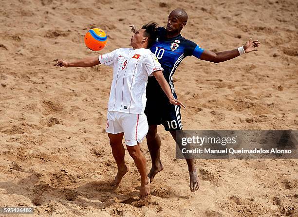 Ozu Moreira of Japan competes for the ball with Train Vinh Phong of Vietnam during the Continental Beach Soccer Tournament match between Japan and...