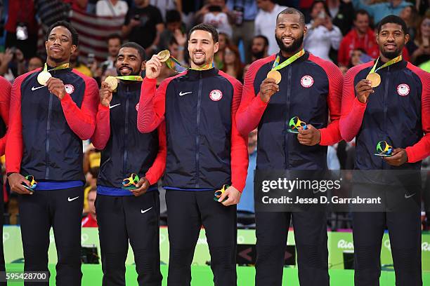 DeMar DeRozan, Kyrie Irving, Klay Thompson, DeMarcus Cousins, and Paul George of the USA Basketball Men's National Team celebrate at the medal...