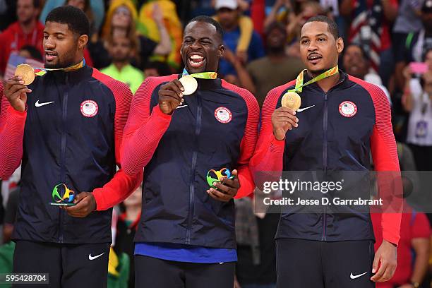 Paul George, Draymond Green, and Carmelo Anthony of the USA Basketball Men's National Team celebrate at the medal ceremony on Day 16 of the Rio 2016...