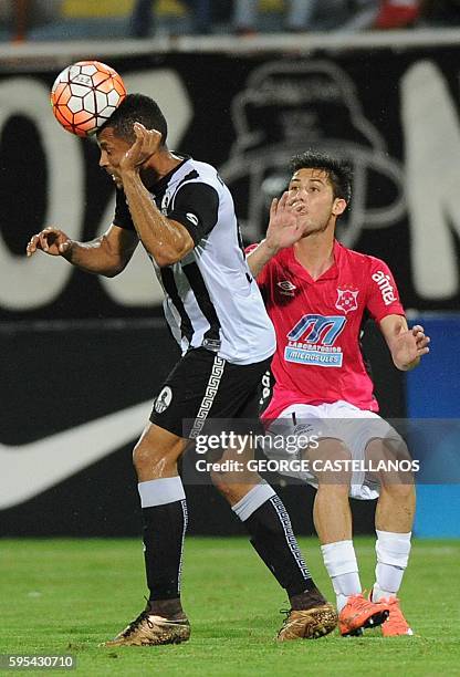 Angel Faria of Venezuela's team Zamora heads the ball as Rodrigo Rivero of Uruguay's Wanderers looks on during their Sudamericana Cup football match...