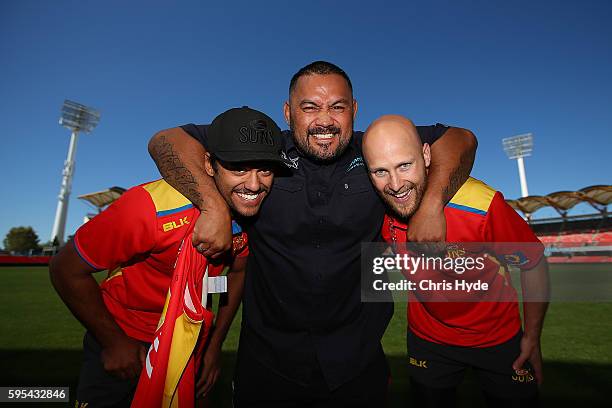 Fighter and Dunamis actor Mark Hunt poses with Aaron Hall and Gary Ablett of the AFL Gold Coast Suns at Metricon Stadium. Hunt on August 26, 2016 in...