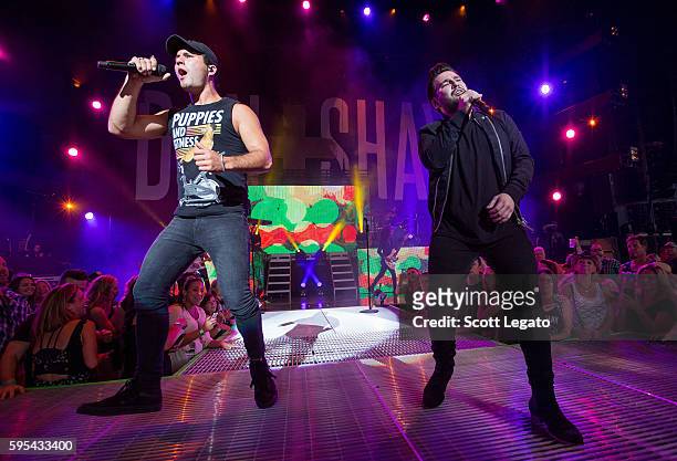 Dan Smyers and Shay Mooney of country music duo Dan + Shay perform in support of the Good For a Good Time Tour 2016 at DTE Energy Music Theater on...