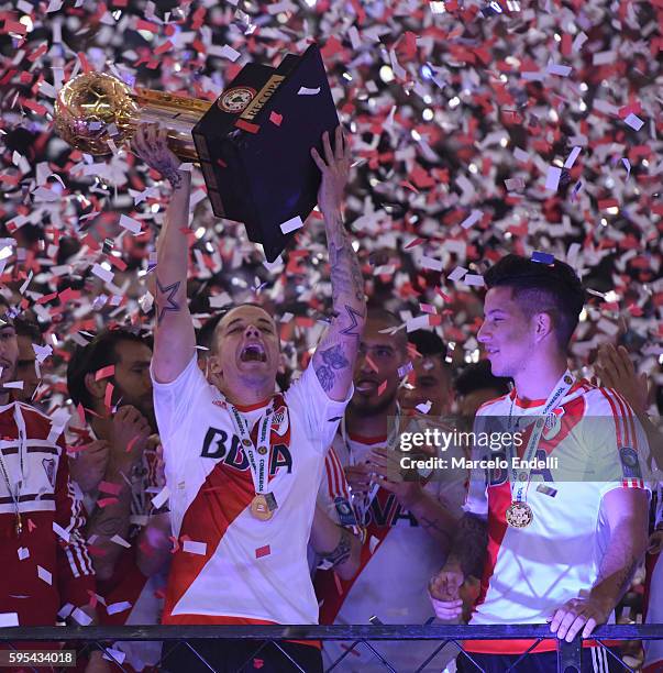 Andres D'Alessandro and Sebastian Driussi of River Plate celebrate with the trophy after winning the Recopa Sudamericana 2016 during a second leg...