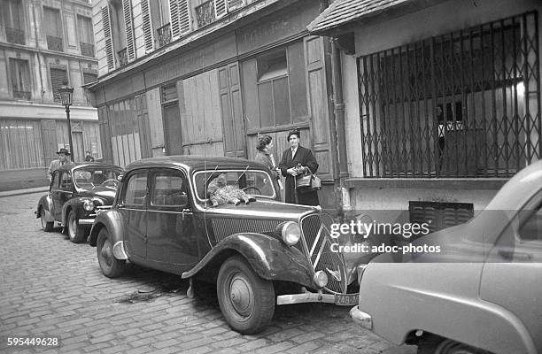 Cats sleeping on a Citroën Traction Avant in Paris . Ca. 1955.