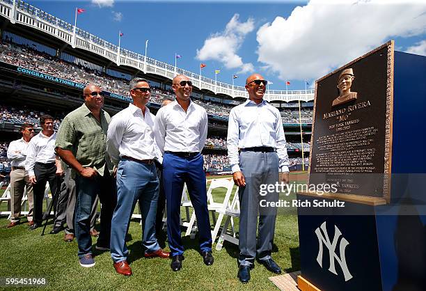 Tino Martinez, Paul O'Neil, Bernie Williams, Jorge Posada and Derek Jeter stand with Mariano Rivera and his plaque during a ceremony in his honor...