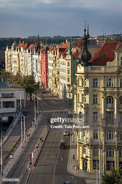 old colourful buildings and normal traffic at sunset in center prague, czech republic, europe - tancici dum stock pictures, royalty-free photos & images