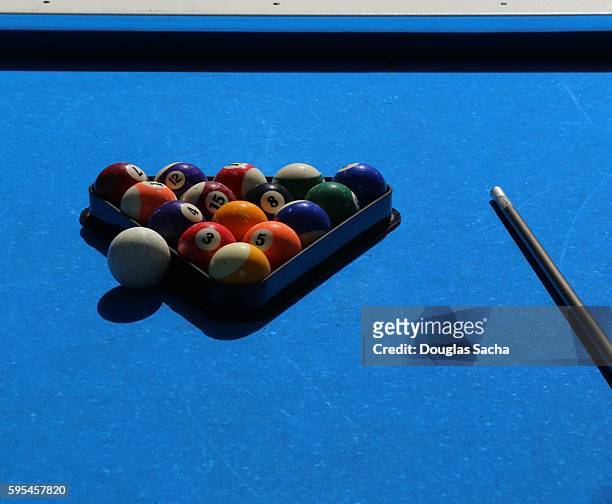 close-up of pool balls by cue on a outdoor blue billiard table - competition group fotografías e imágenes de stock