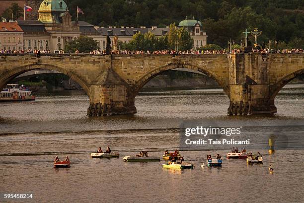 charles bridge (karlův most) and little boats in center prague, czech republic, europe - tancici dum stock pictures, royalty-free photos & images