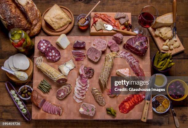 charcuterie on cutting board - charcuterie stock pictures, royalty-free photos & images