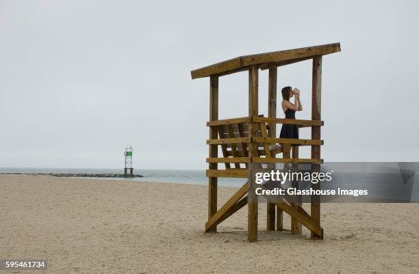 young woman standing in lifeguard tower - hyannis port stock pictures, royalty-free photos & images
