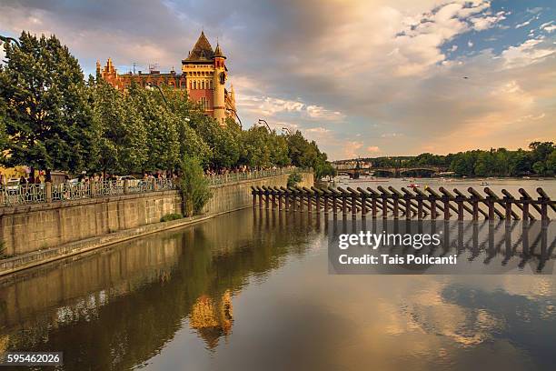 smetana embankment, vltava river (moldau) at sunset in prague, czech republic - tancici dum stock pictures, royalty-free photos & images