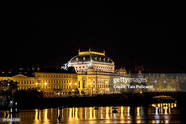 the national theatre (národní divadlo) golden lights reflected in the vltava river at night. prague, czech republic, europe - the moldau river stock pictures, royalty-free photos & images