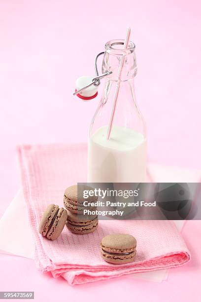 chocolate macarons and bottle of milk - chocolate milk bottle stock pictures, royalty-free photos & images