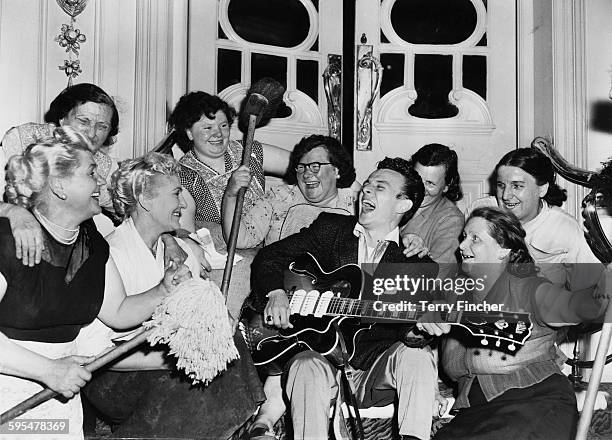 American rhythm and blues, and rock & roll singer Charlie Gracie entertaining the cleaning staff at the Hippodrome, London, where he is rehearsing...