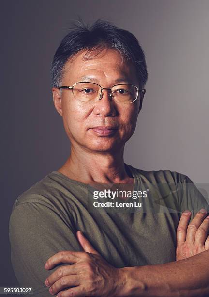 serious old man with folded arms - old man and glasses ストックフォトと画像