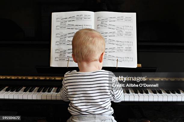 baby boy playing the piano - prodigy stock pictures, royalty-free photos & images