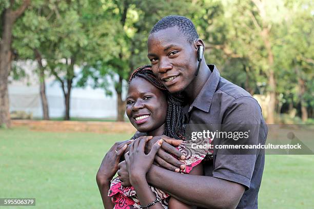 two young lovers in a park - commerceandculturestock stock pictures, royalty-free photos & images