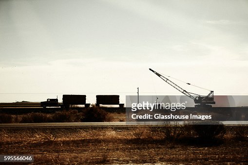 Crane and Trucks Transporting Hay Along Desert Highway, Arizona, USA