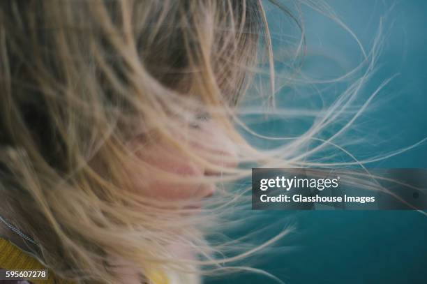 young girl with windblown hair - wind in face stock pictures, royalty-free photos & images