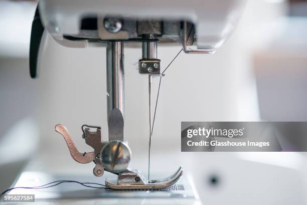 sewing machine mechanism with thread passing through needle - sewing machine stock pictures, royalty-free photos & images