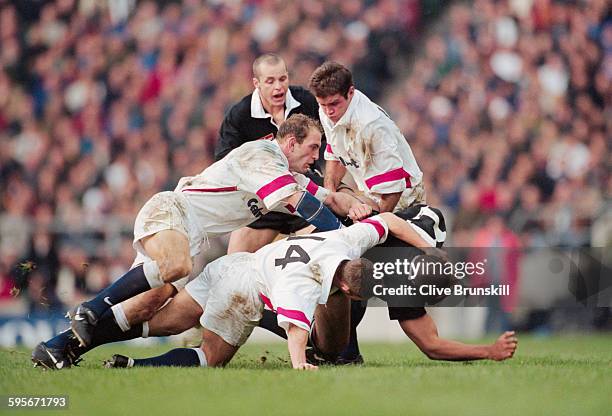 David Rees, Lawrence Dallaglio and Phil de Glanville of England tackle Jonah Lomu of New Zealand during the match against the New Zealand All Blacks...