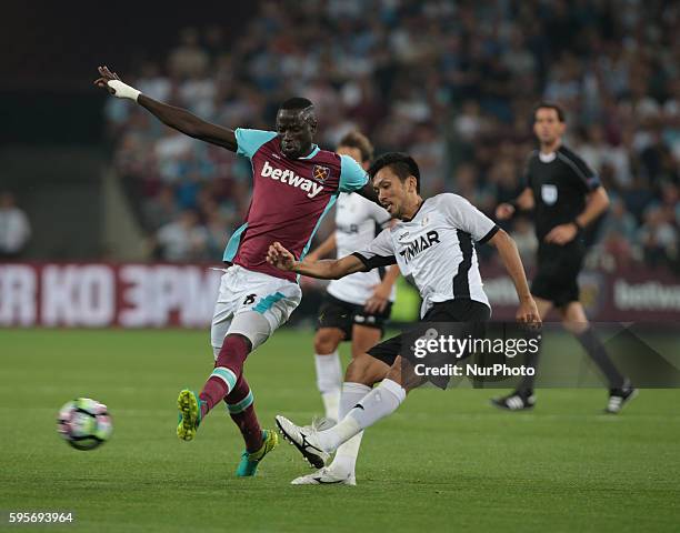 Astra Giurgiu Takayuki Seto holds of West Ham United's Cheikhou Kouyateduring Europa League play-off match between West Ham v FC Astra Giurgiu, in...