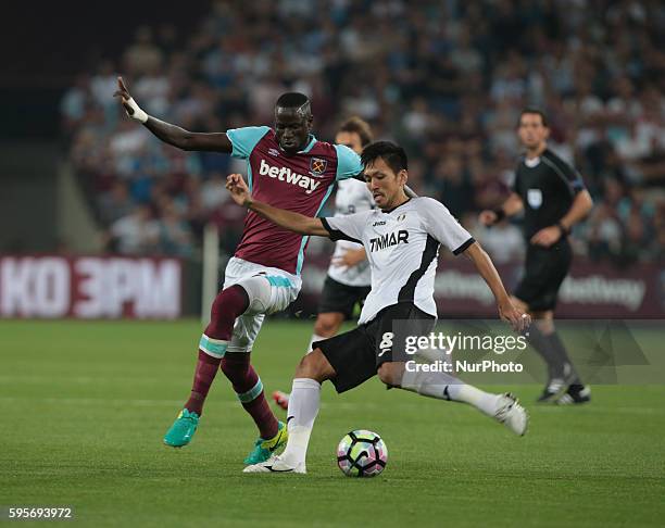 Astra Giurgiu Takayuki Seto holds of West Ham United's Cheikhou Kouyateduring Europa League play-off match between West Ham v FC Astra Giurgiu, in...