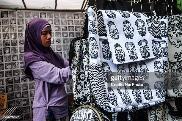 Woman show local product in event Yogyakarta Art Festival, Yogyakarta, Indonesia, on August 22, 2016. Yogyakarta Art Festival show creative industry...