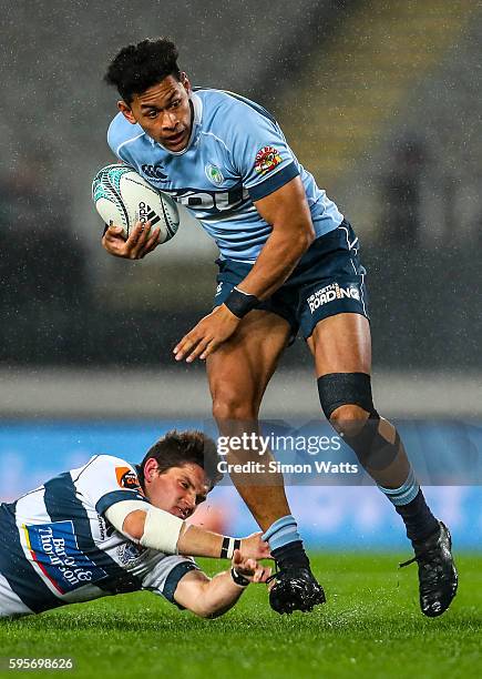 Solomon Alaimalo of Northland beats the tackle of Simon Hickey of Auckland during the round two Mitre 10 Cup match between Auckland and Northland at...