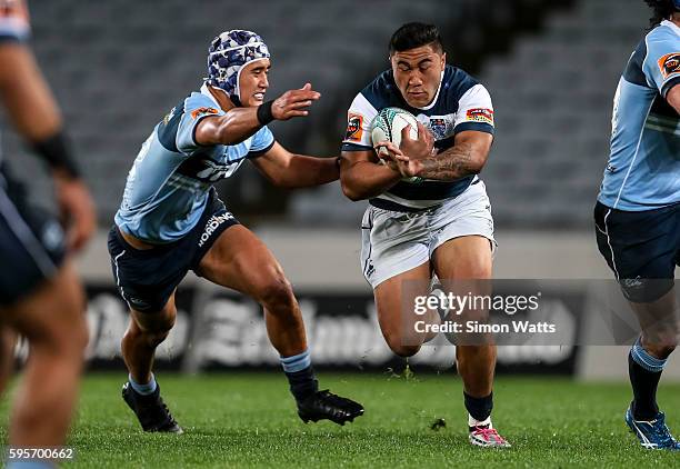 Vince Aso of Auckland beats the tackle of Tamati Tua of Northland during the round two Mitre 10 Cup match between Auckland and Northland at Eden Park...