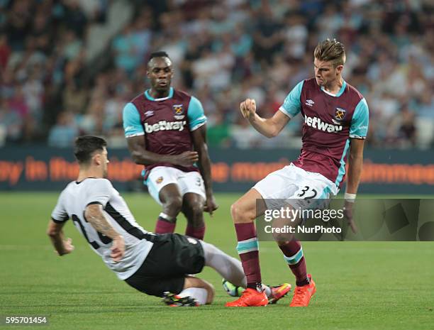 West Ham United's Reece Burke gets tackled by FC Astra Giurgiu Cristian Sapunaru during Europa League play-off match between West Ham v FC Astra...