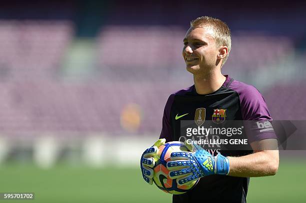 Barcelona's Dutch goalkeeper Jasper Cillessen poses on the pitch during his official presentation at the Camp Nou stadium in Barcelona on August 26...