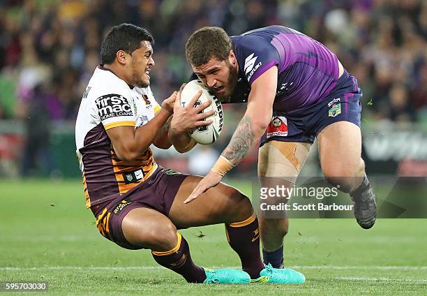 Kenneath Bromwich of the Storm is tackled by Anthony Milford of the Broncos during the round 25 NRL match between the Melbourne Storm and the...