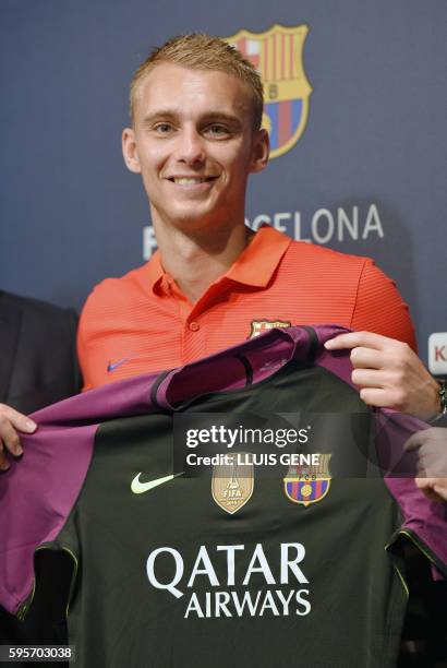 Barcelona's Dutch goalkeeper Jasper Cillessen poses with his new jersey after his official presentation at the Camp Nou stadium in Barcelona on...