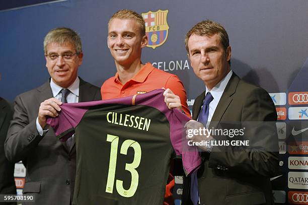 Barcelona's Dutch goalkeeper Jasper Cillessen poses with his new jersey flanked by Barcelona's third Vice-President Jordi Mestre and Barcelon's...