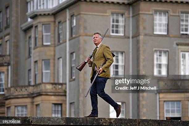 Auctioneer Gavin Gardiner holds a pair of 12-bore round action ejector guns made byJohn Dickson & Sons,at Gleneagles Hotel on August 26, 2016 in...