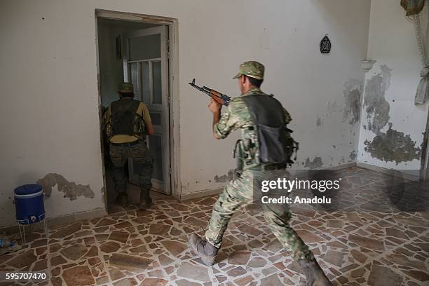 Members of Free Syrian Army carry out a house to house search, quitted by Daesh members, in Jarabulus district of Aleppo, Syria after taking control...