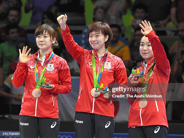 Table tennis Women's Team bronze medalists Ai Fukuhara, Kasumi Ishikawa and Mima Ito of Japan pose for photographs on the podium at the medal...