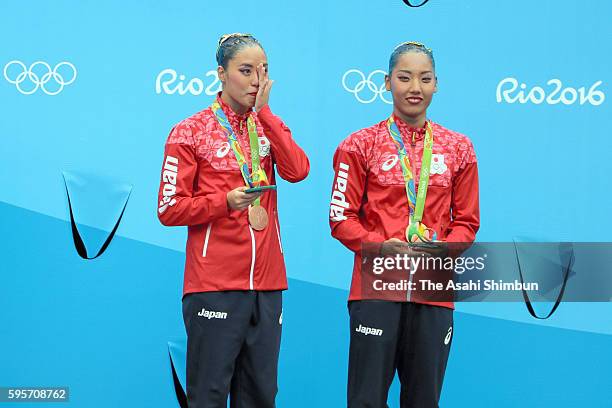 Bronze medalists Yukiko Inui and Risako Mitsui of Japan celebrate on the podium at the medal ceremony for the Synchronised Swimming Duets on Day 11...