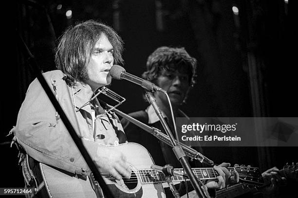 Neil Young, and Robbie Robertson of The Band, perform during The Last Waltz at Winterland on November 25, 1976 in San Francisco, California.