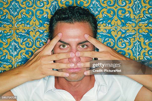 man holding fingers before face - double facepalm stock pictures, royalty-free photos & images