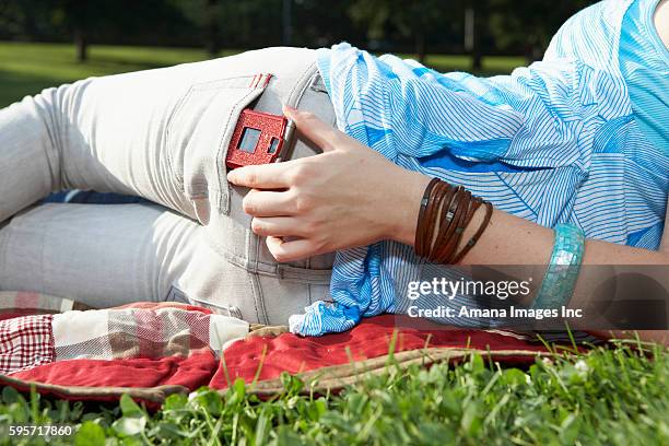 teenage girl taking mobile phone from back pocket - phone in back pocket stock pictures, royalty-free photos & images