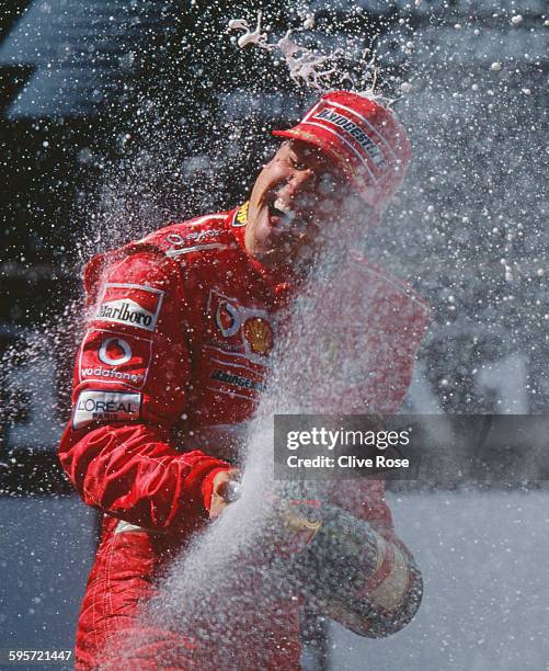 Michael Schumacher of Germany, driver of the Scuderia Ferrari Marlboro Ferrari F2003-GA Ferrari V10 sprays champagne as he celebrates winning the...