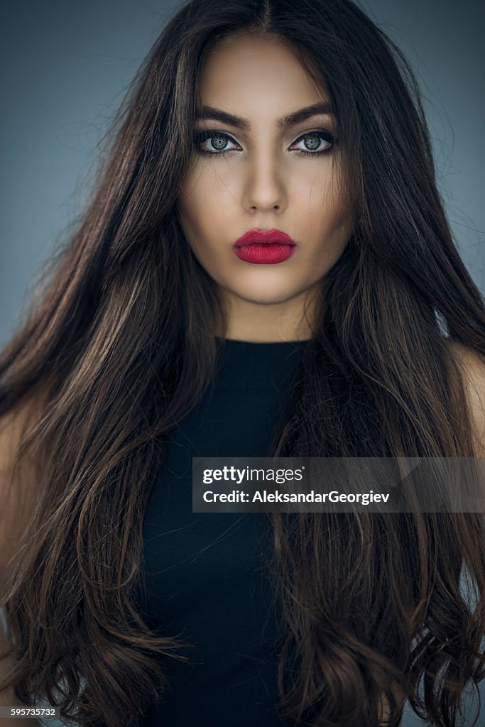 Fashion Portrait of Beautiful Young Woman with Long Hair