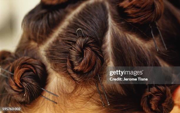 locks of hair twisted up and secured by hairpins, close-up - hair pin stock pictures, royalty-free photos & images